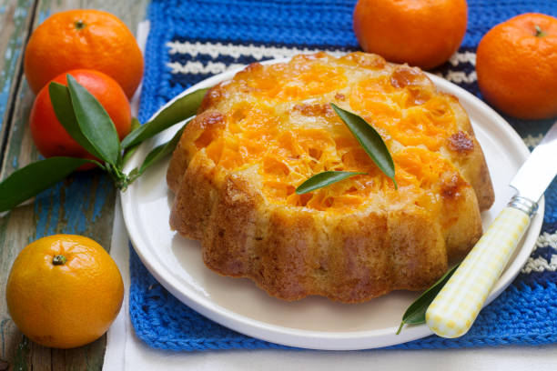 istock Mandarin cake and tangerines on rustic background. 912735702