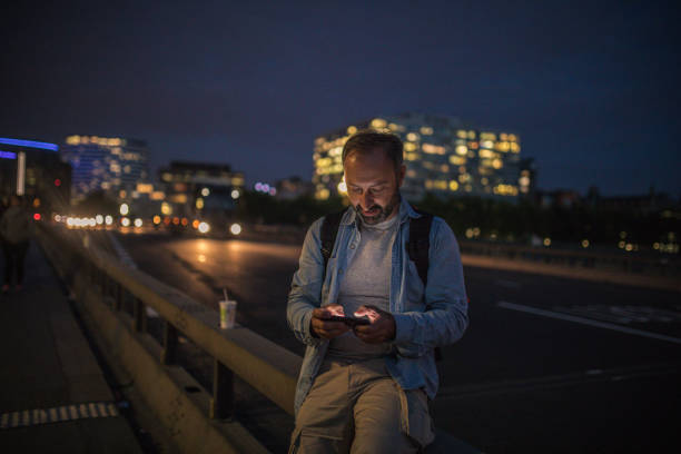 istock Man texting on the street 912743200
