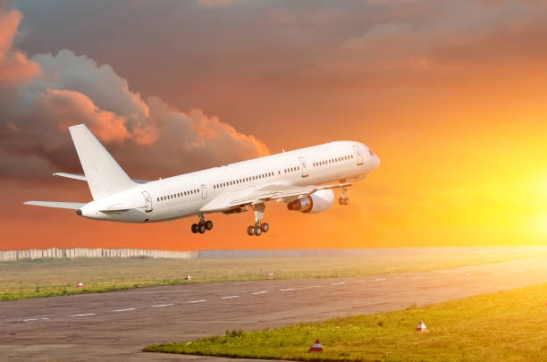 istock Passenger airplane landing at sunset on a runway. 912745252