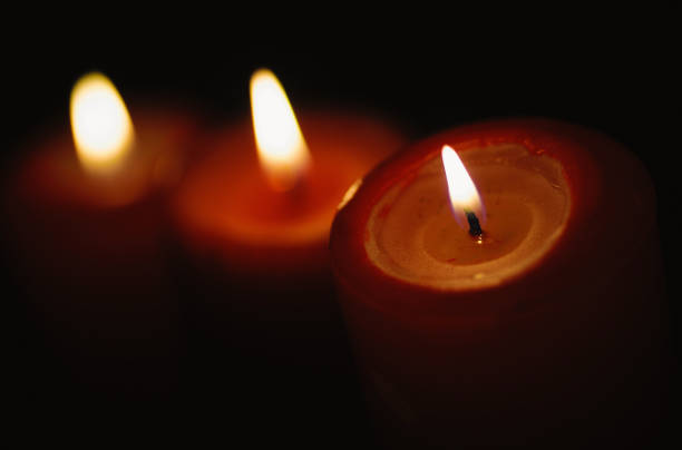 istock Beautiful candles burning on a black backgrounds 912745348