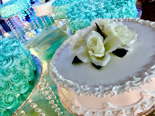 quinceanera cakes beautifully decorated with white and aqua frosting. Cakes frosted in white and aqua blue candles, decorated for quinceanera quinceanera stock pictures, royalty-free photos & images