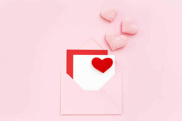 istock Valentine card in envelope with pink hearts 912748252