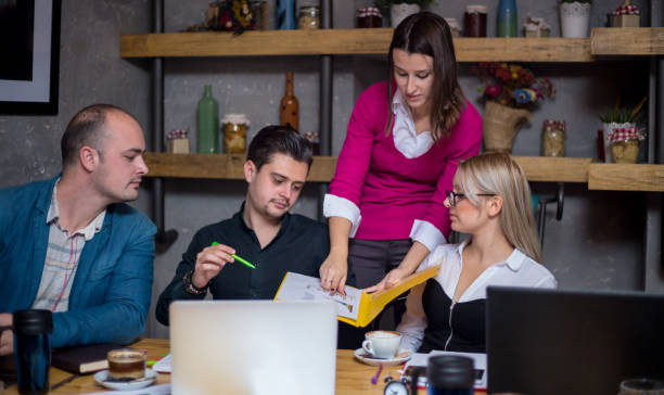 istock Three Businesspeople Working At Laptop In cafe 912748664