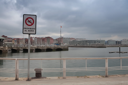 Prohibition sign on the waterfront in the port of Gijón, Spain.