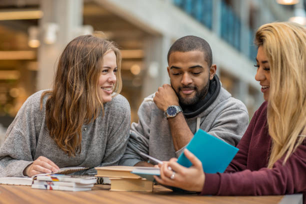 istock Multi ethnic university adult students learning languages together in a study hall 912750970