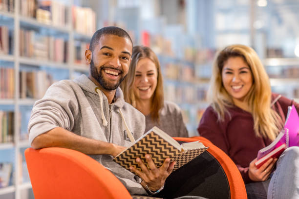 istock Multi ethnic university adult students learning languages together in a public library 912751080