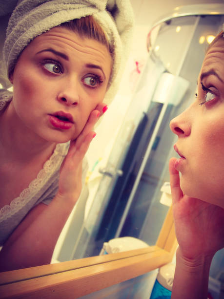 istock Woman looking at her reflection in mirror 912751714