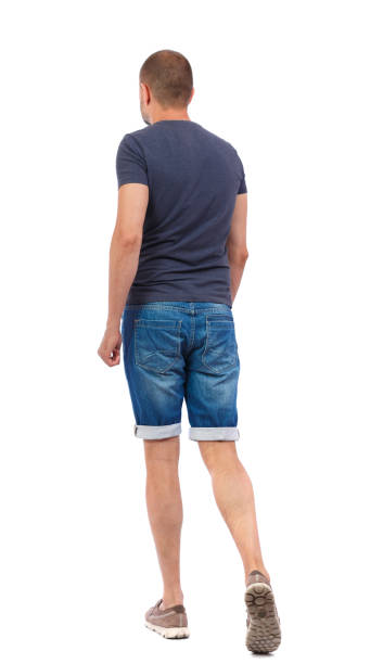 istock Back view of going  handsome man. walking young guy . 912754910
