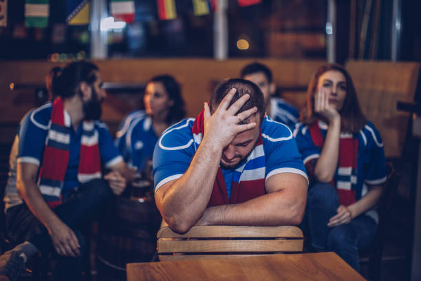 istock Disappointed man watching football game 912754950
