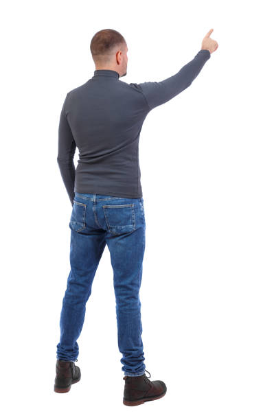 istock Back view of  pointing young men in  shirt and jeans. 912755542