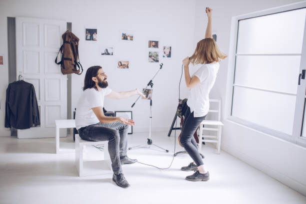 istock Couple having fun in music studio 912758204