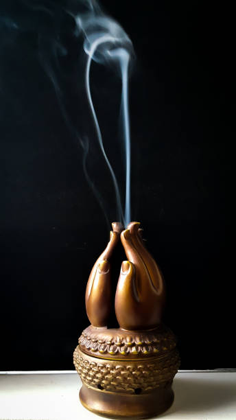istock Prayer hands with incense smoke curling into the air 912760886