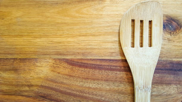 istock Slotted wooden spoon on a cutting board in the kitchen 912761278