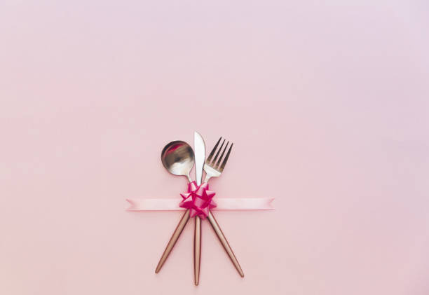 Fork, knife, spoon, silverware with on pink background for catering, menu, email, banner, restaurant party celebration