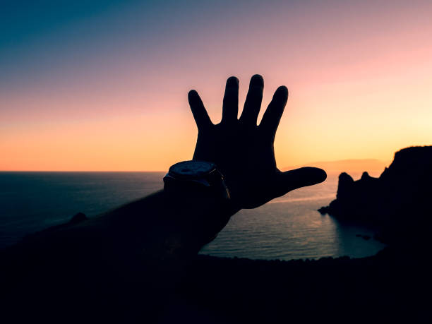 istock hand of man on sunset symbolizing freedom 912769464