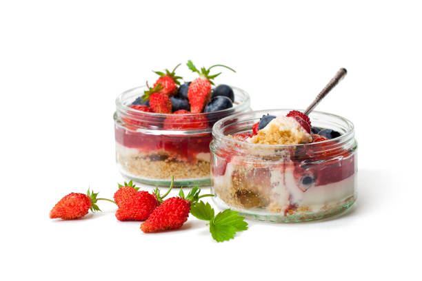 istock Mini  wild forest berries cheesecake in a glass pots isolated on white background 912770032