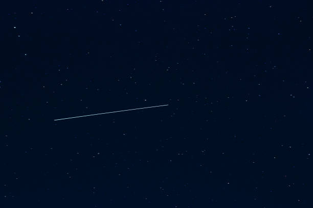 istock shooting star against dark blue starry night sky 912775982