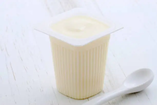 Delicious, nutritious and healthy fresh plain yogurt cup. On vintage retro styling.