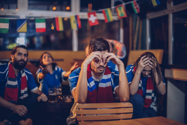 istock Friends watching football game 912780022