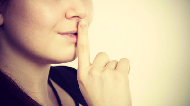 istock Woman showing silence gesture with finger 912782368