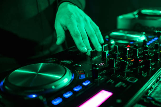 istock hand moving of DJ controllers on music control panel in night club 912783012