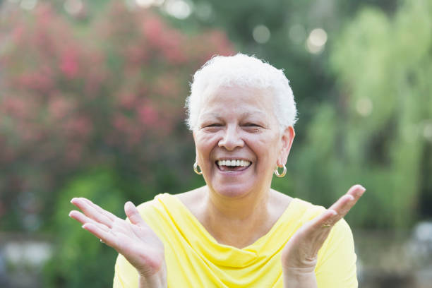 istock Senior Hispanic woman standing outdoors, laughing 912785292