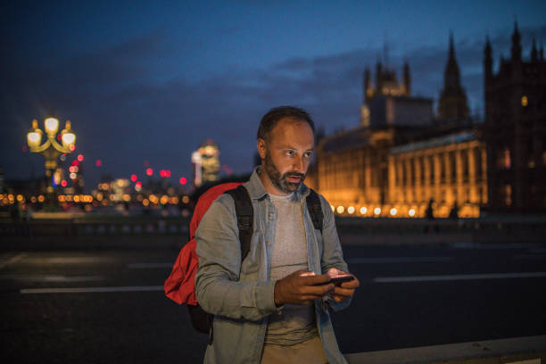 istock Tourist man texting on the street 912785550