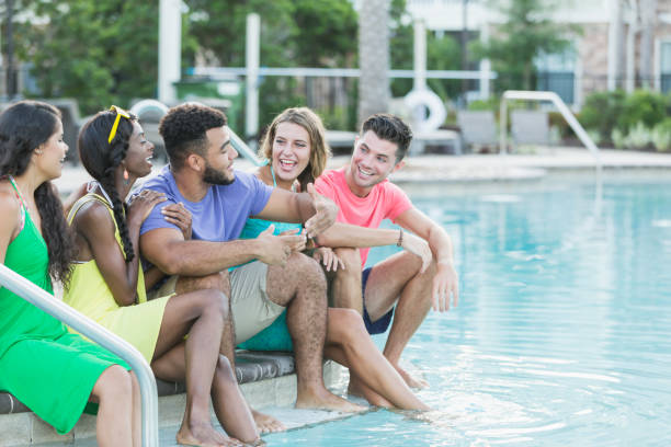 istock Five multi-ethnic young adults by swimming pool 912785592