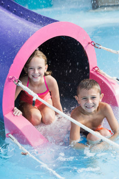 istock Children on water slide smiling at camera 912786668