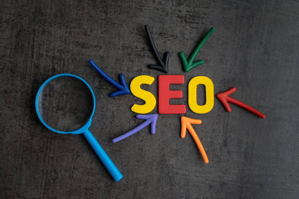 SEO, Search Engine Optimization ranking concept, magnifying glass with arrows pointing to alphabets abbreviation SEO at the center of cement wall chalkboard, the idea of promote traffic to website