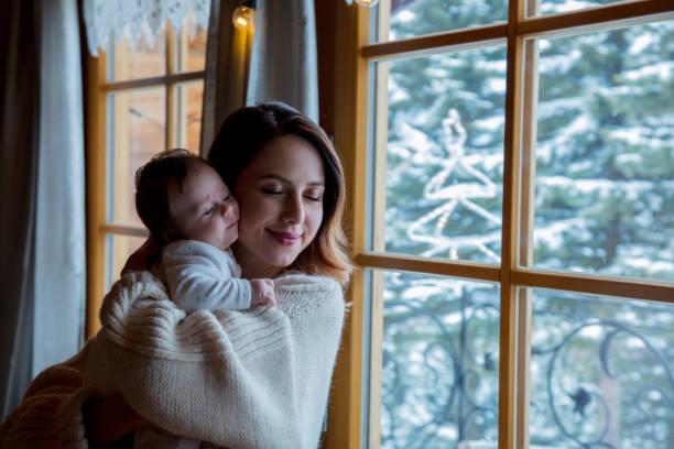 istock Young mother holding child indoor 912790198
