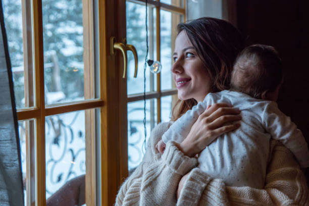 istock Young mother holding child indoor 912790232