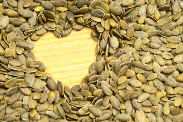 istock heart of pumpkin seeds on a cutting board 912793808