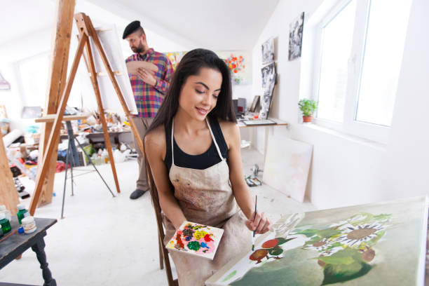 istock Couple painters working in atelier 912795178