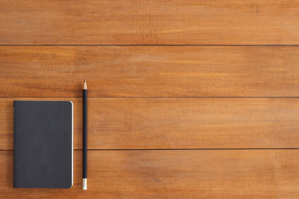 istock Minimal work space - Creative flat lay photo of workspace desk. Office desk wooden table background with mock up notebooks and pencil and plant. Top view with copy space, flat lay photography. 912795854