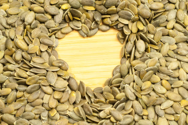 istock heart of pumpkin seeds on a cutting board 912796318
