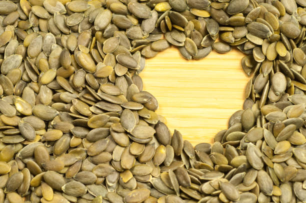 istock heart of pumpkin seeds on a cutting board 912796322