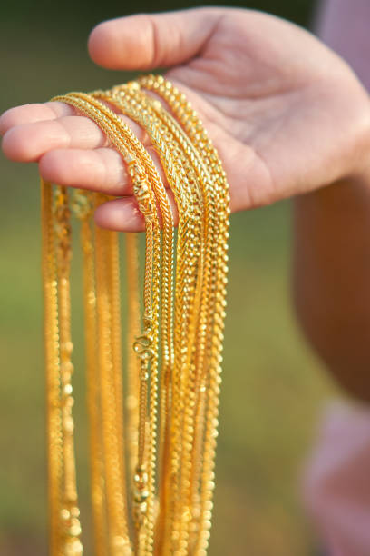 gold jewelry in lady hands.