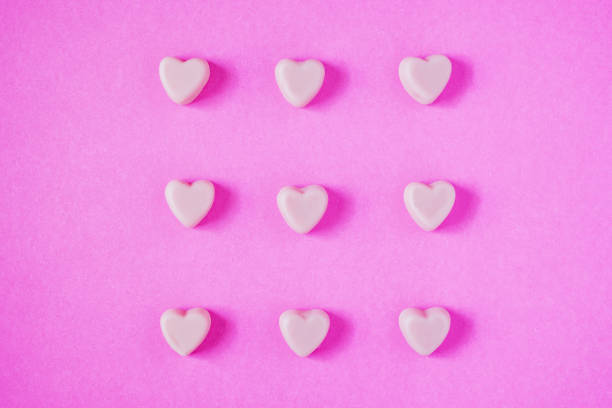 istock valentine candy hearts shape on pink background 912802904