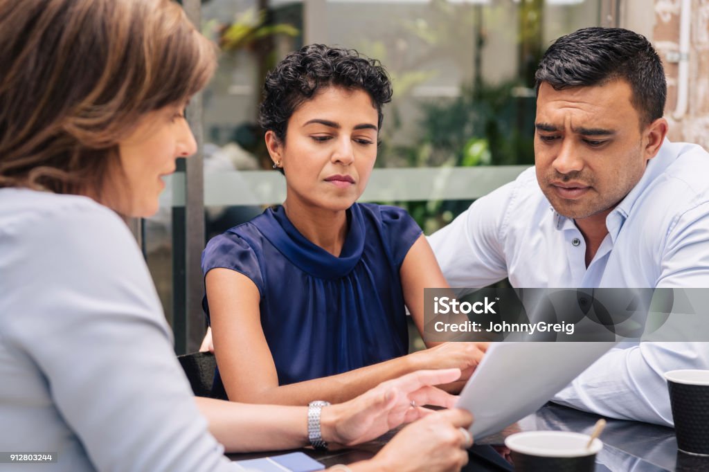 Serious couple receive professional advice Serious mature couple receive professional advice Legal System Stock Photo