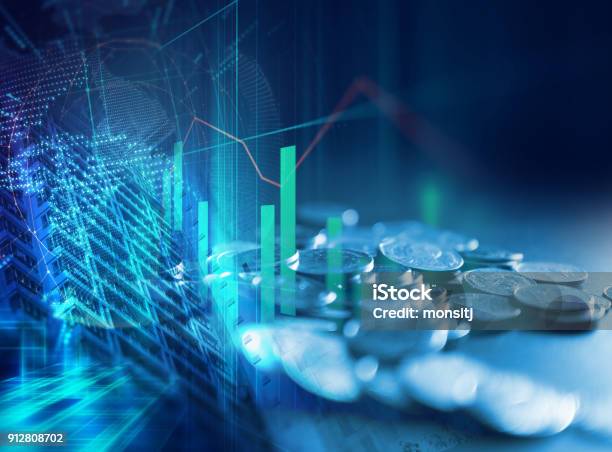 Pile Of Coins On Technology Financial Graph Background Stock Photo - Download Image Now