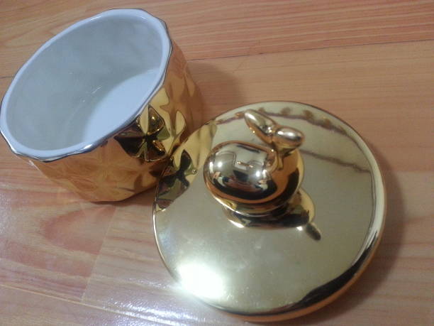 istock Little golden pot with dolphin lid handle 912819512