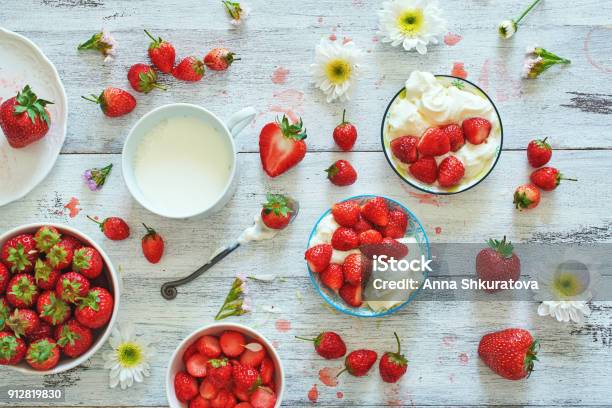 Photo libre de droit de Vue De Dessus De Fraise Fraîche Dans Des Bols De Crème Fouettée Et La Tasse De Lait Sur Tableau Blanc banque d'images et plus d'images libres de droit de Fraise