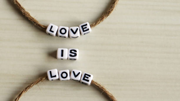 istock Thread an alphabet through a rope. LOVE IS LOVE 912820136