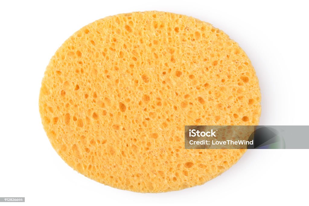 Oval yellow sponge cleansing puff for face or cleaning surface texture isolated on white background on top view Cleaning Sponge Stock Photo