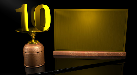 Rendering 3D Wooden trophy with number 10 in gold and golden plate with space to write on mirror table in black background. Commemorative Trophy number 10 for celebrating anniversaries or important dates