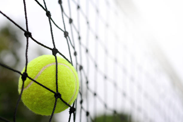 istock Close up Tennis ball hitting to net 912833316