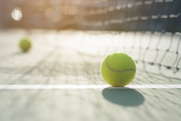 istock Tennis ball on blur net background 912833430