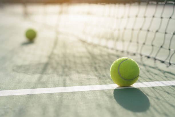 istock Tennis ball on blur net background 912833436
