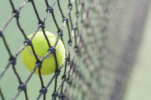 istock Close up Tennis ball hitting to net 912833450